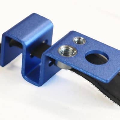Blue metal mounting bracket with screws for industrial equipment.