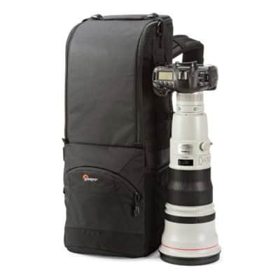 Camera with telephoto lens and backpack for photography gear.